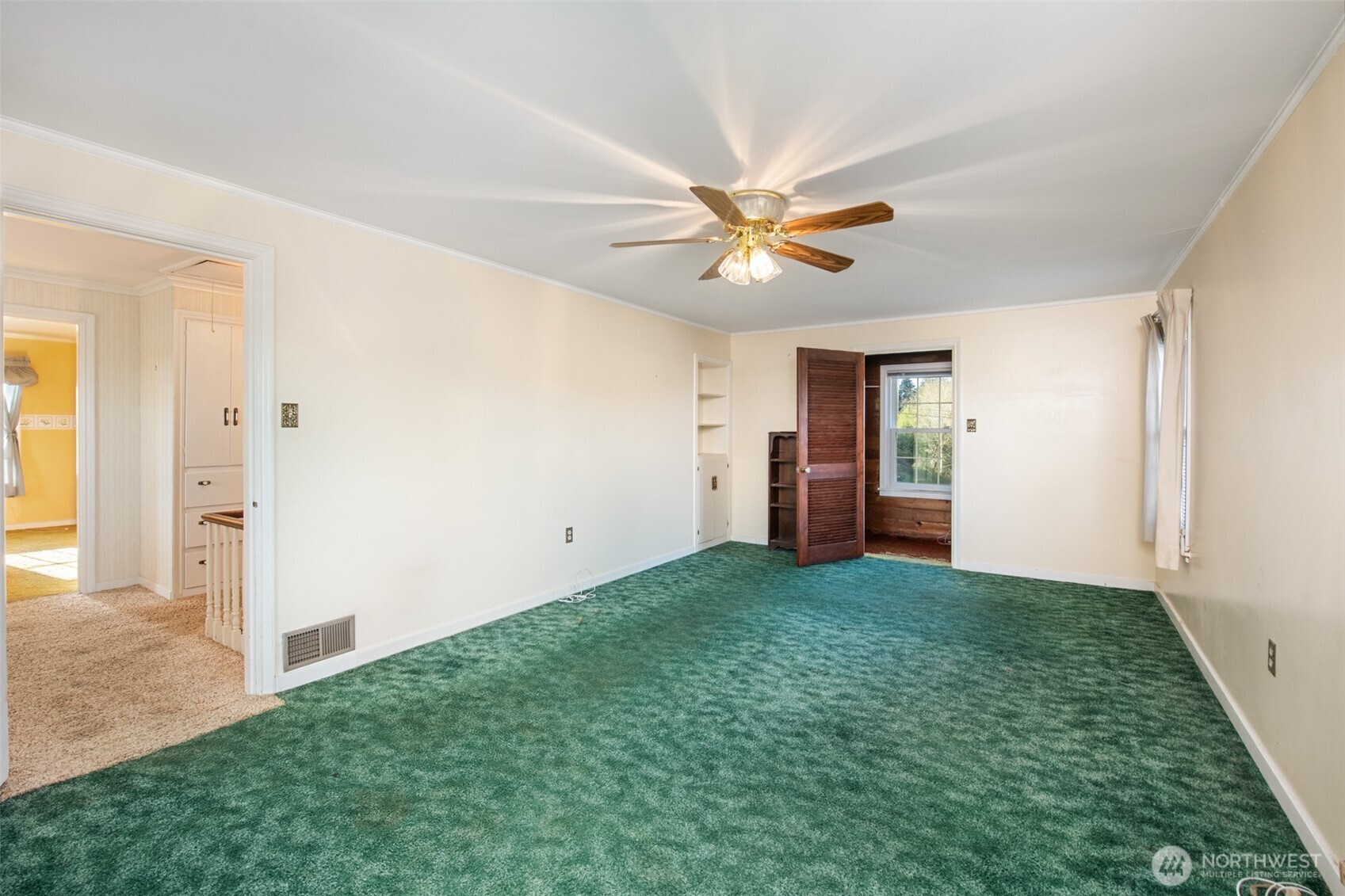 614 1st Avenue Aberdeen, WA 98520 - Photo 19 of 38 a view of a big room with closet and a chandelier fan