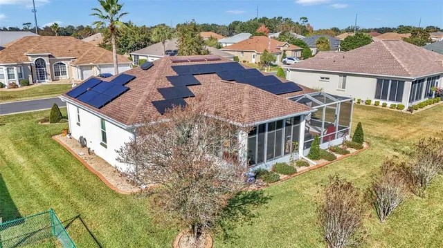 an aerial view of residential houses with yard