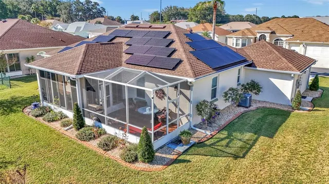 an aerial view of multiple houses with a yard