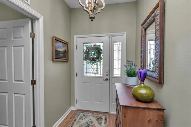 a living room with a window and chandelier