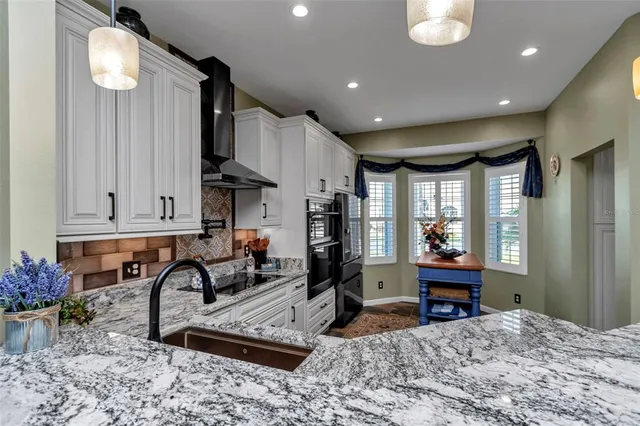 a kitchen with furniture a refrigerator and a sink