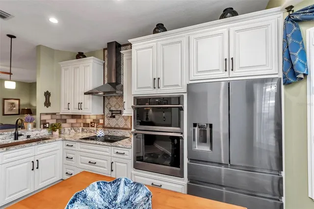 a kitchen with granite countertop stainless steel appliances and wooden cabinets