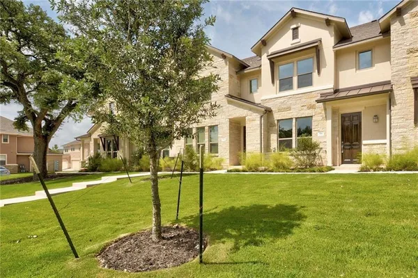 a front view of a house with a yard