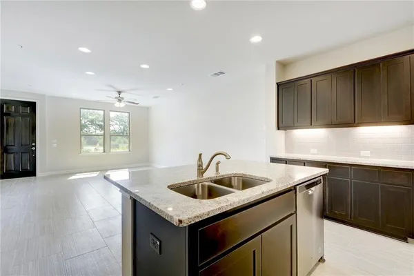 a kitchen with granite countertop a sink and a window