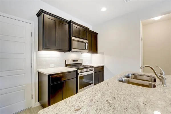 a kitchen with a stove and a microwave
