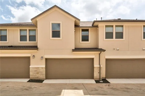 a front view of a house with garage