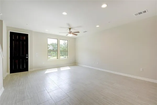 an empty room with windows and closet