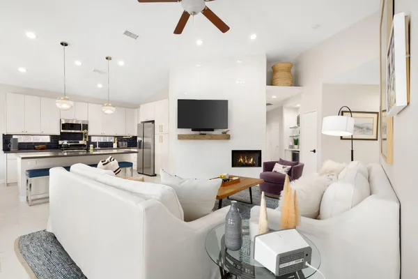 a kitchen with kitchen island a stove a sink a refrigerator a center island a stove and a refrigerator with wooden floor