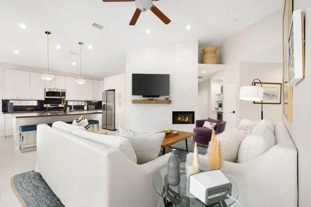 a kitchen with kitchen island a stove a sink a refrigerator a center island a stove and a refrigerator with wooden floor