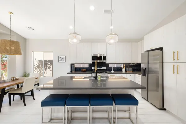 a kitchen with sink a stove and cabinets