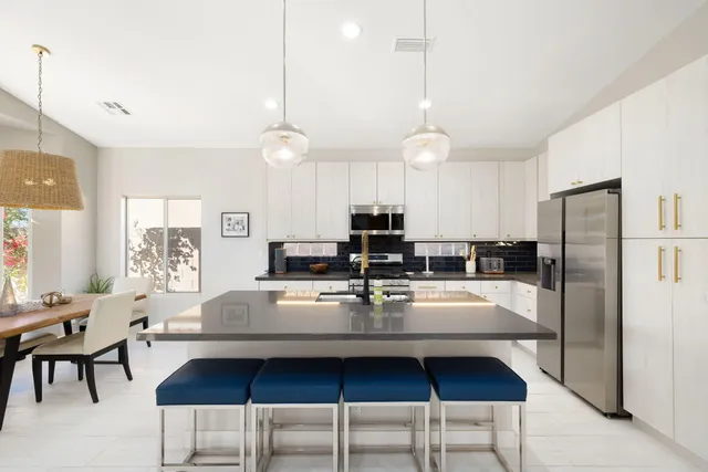 a kitchen with sink a stove and cabinets