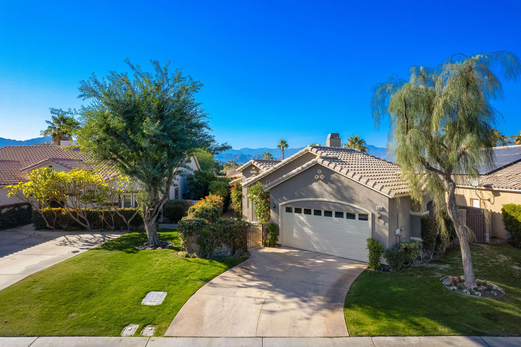 45809 Crosswater Street Indio, CA 92201 - Photo 2 of 48 a view of a building with a garden