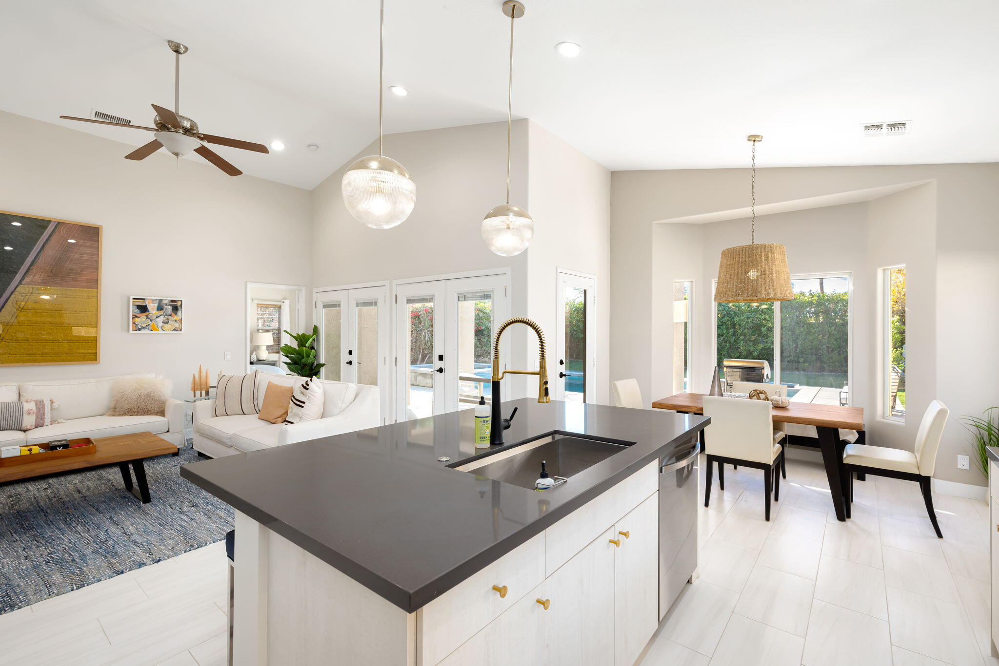 45809 Crosswater Street Indio, CA 92201 - Photo 23 of 48 a kitchen with a table chairs and white cabinets