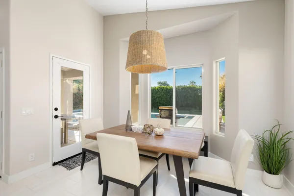 a view of a dining room with furniture wooden floor and a chandelier