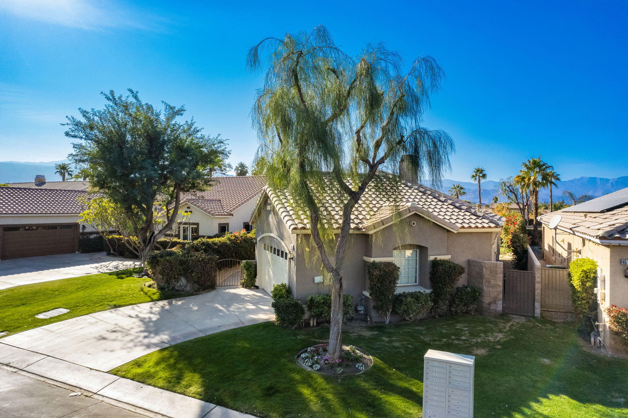 45809 Crosswater Street Indio, CA 92201 - Photo 3 of 48 a front view of a house with a garden and yard