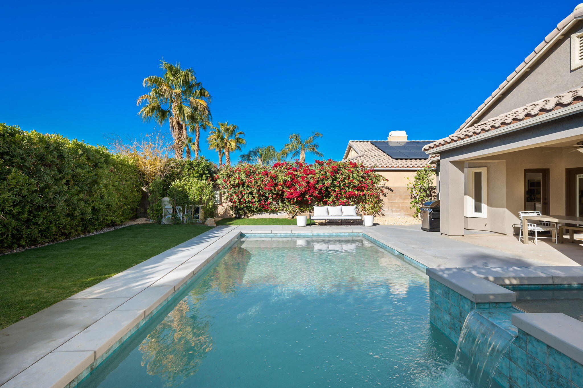 45809 Crosswater Street Indio, CA 92201 - Photo 32 of 48 a view of a house with swimming pool and a yard