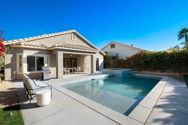 a view of a swimming pool with a yard