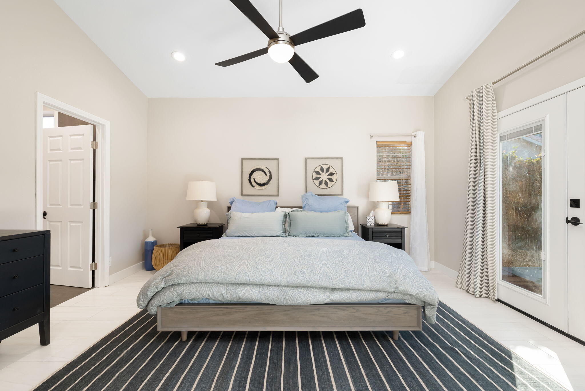 45809 Crosswater Street Indio, CA 92201 - Photo 39 of 48 a bedroom with a large bed and a chandelier