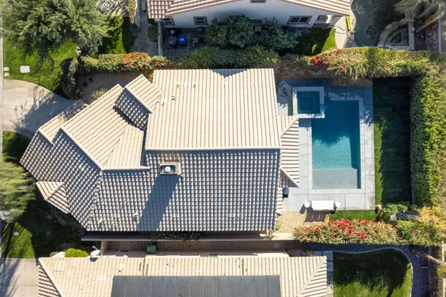 a view of a house with a wooden bench