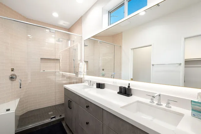 a bathroom with a sink a shower and a mirror