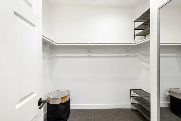 a view of kitchen with hallway and wooden floor