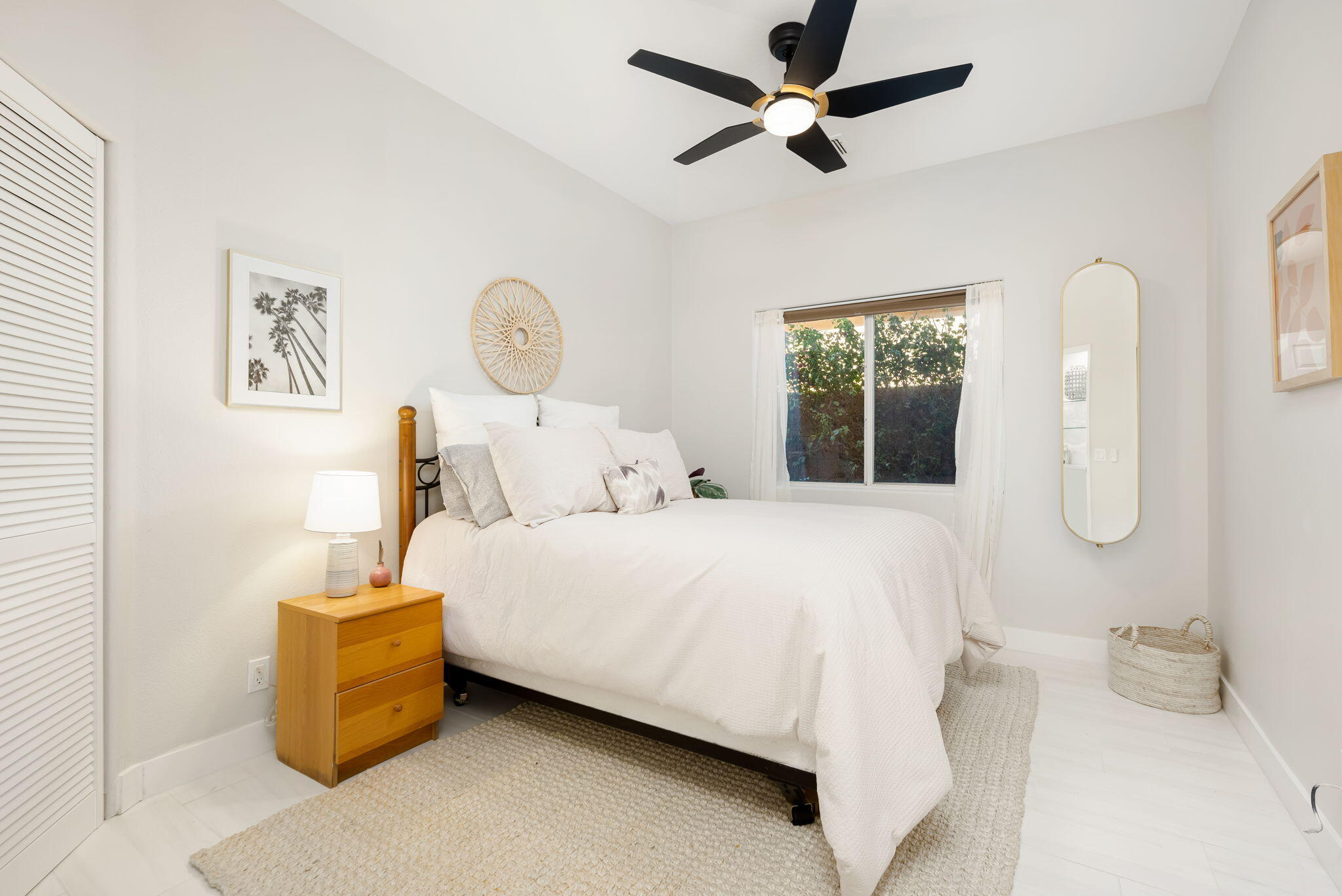 45809 Crosswater Street Indio, CA 92201 - Photo 45 of 48 a bedroom with a bed and a chandelier