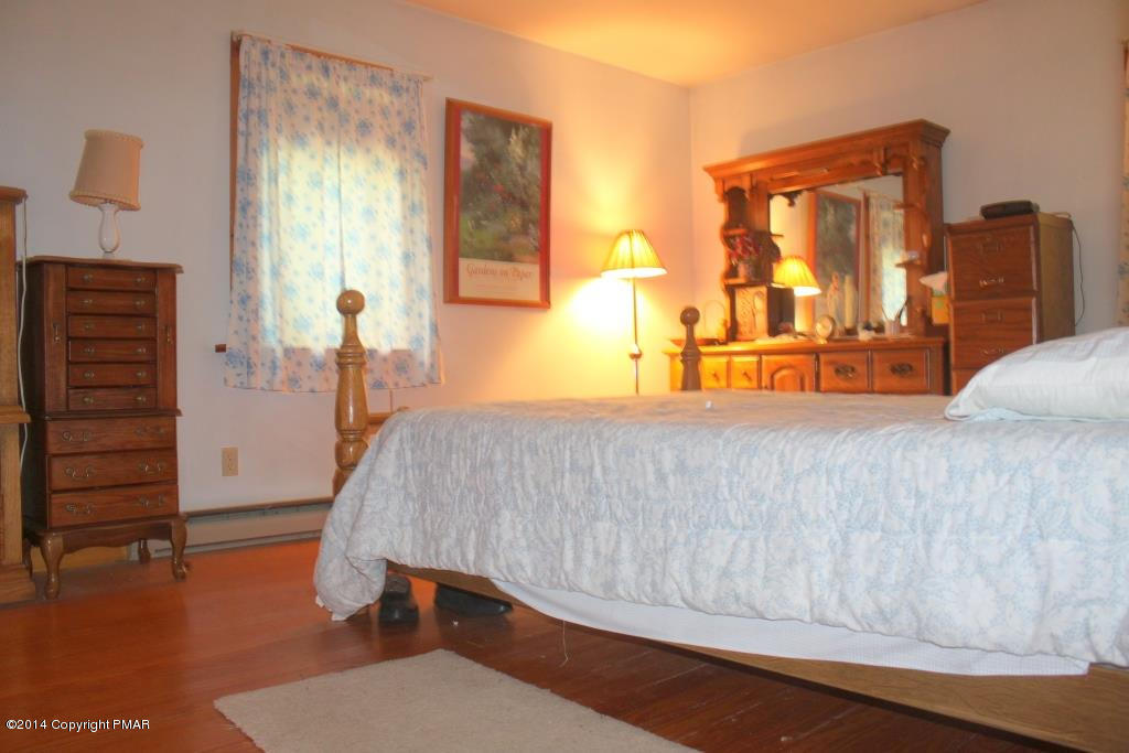 520 Gernerd Road Effort, PA 18330 - Photo 8 of 15 a bedroom with a bed and wooden floor