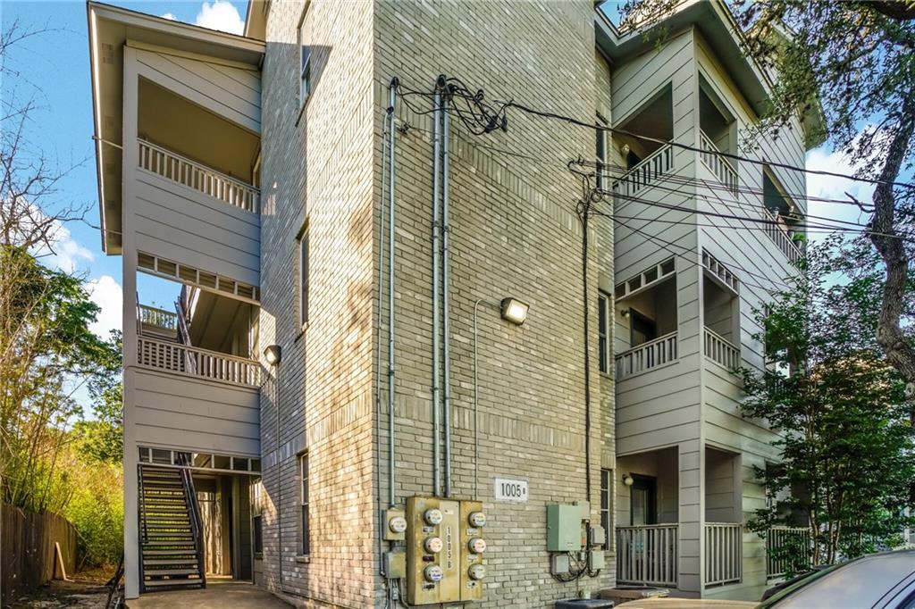 1005 North LBJ Drive, Unit B2 San Marcos, TX 78666 - Photo 12 of 13 a view of a brick house with large windows