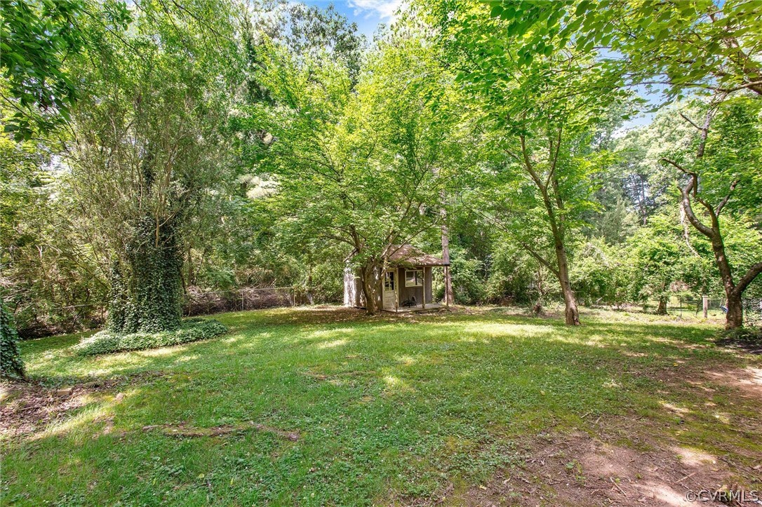 3417 West Hundred Road Chester, VA 23831 - Photo 21 of 23 a big yard with trees in the background