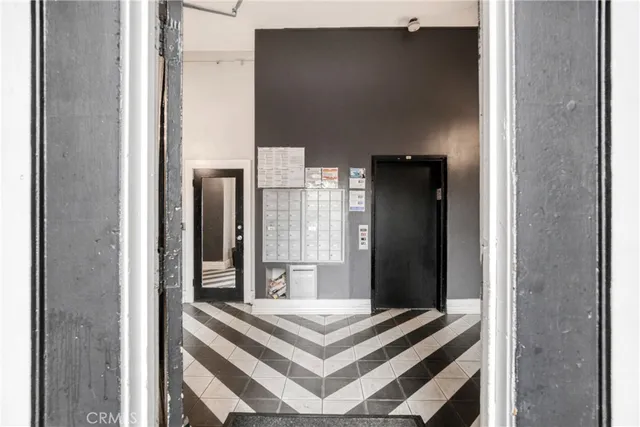 an empty room with wooden floor and cabinet