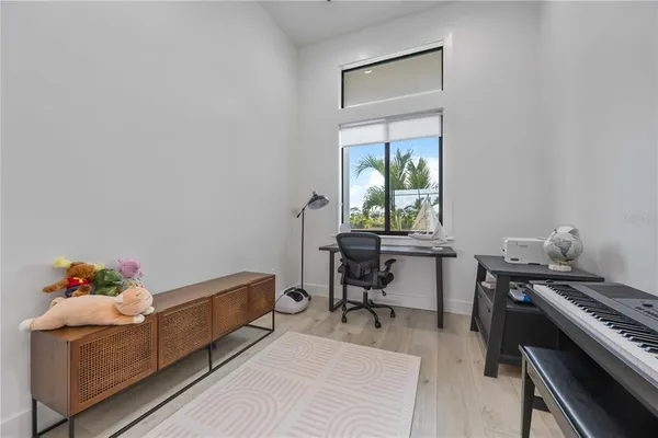 a kitchen with a table chairs microwave and cabinets
