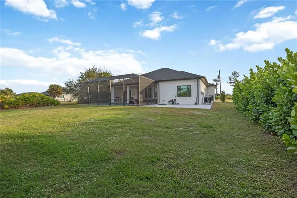 a view of a house with a yard and balcony