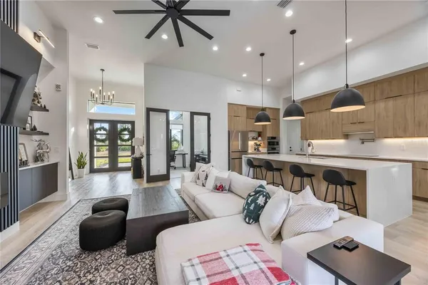 a large kitchen with stainless steel appliances kitchen island a large counter top and a wooden floors