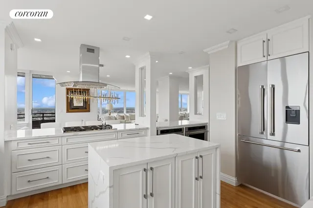 a kitchen with stainless steel appliances granite countertop a stove a sink and a refrigerator