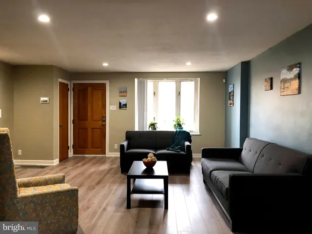 a living room with furniture windows and a flat screen tv