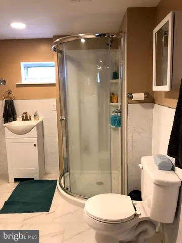 a bathroom with a sink a toilet a tub and shower