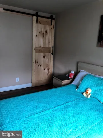 a view of an empty room with a fireplace and painted walls