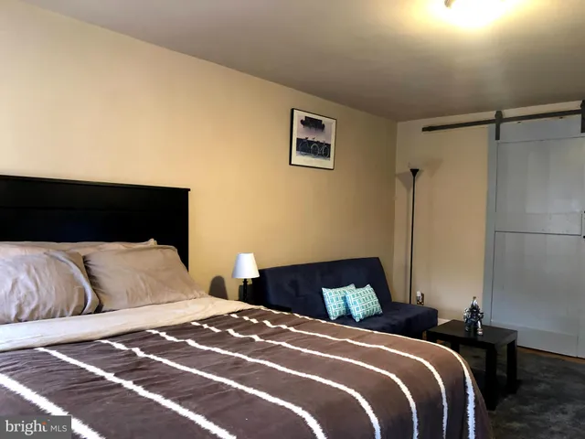 a bedroom with a bed and a night stand