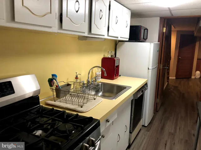 a kitchen with a stove and a refrigerator