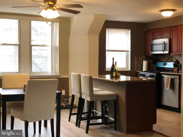 a dining room with furniture and window