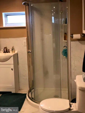 a bathroom with a toilet a sink and shower