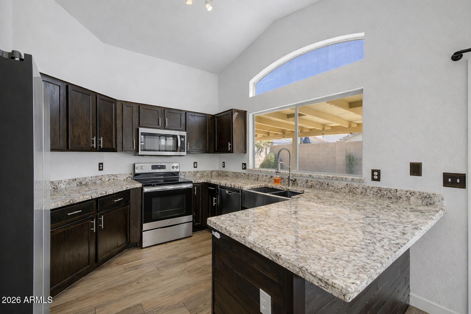 109 West Mohawk Lane Phoenix, AZ 85027 - Photo 2 of 23 a kitchen with granite countertop wooden cabinets and a granite counter tops