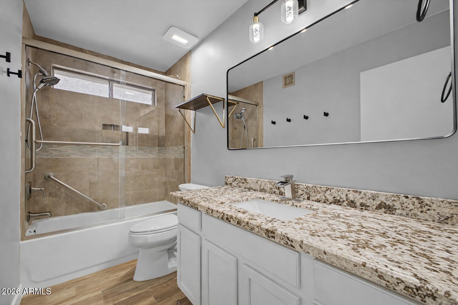 109 West Mohawk Lane Phoenix, AZ 85027 - Photo 9 of 23 a bathroom with a granite countertop sink toilet and shower
