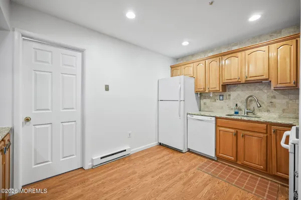 a kitchen with a refrigerator sink and cabinets