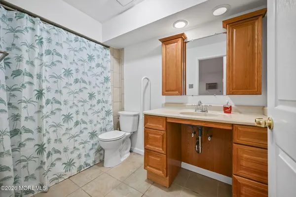 a bathroom with a sink toilet and mirror