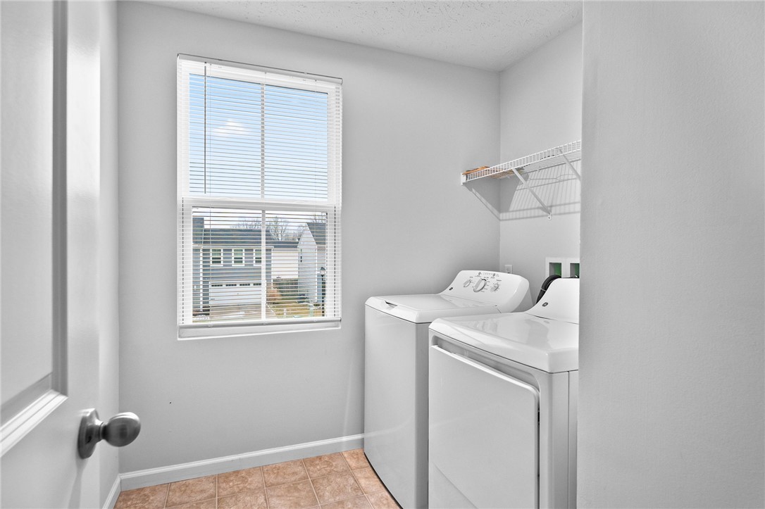 226 Golden Gate Avenue Springfield, OH 45506 - Photo 18 of 20 This dedicated laundry area features a window and tiled flooring.