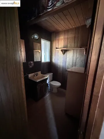 a bathroom with a sink a toilet a mirror and vanity