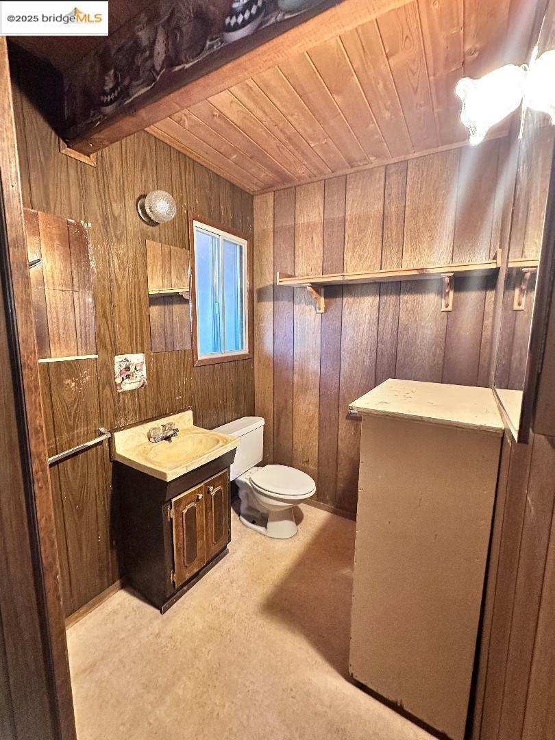 22071 Fallview Lane Sonora, CA 95370 - Photo 10 of 17 a bathroom with a sink a toilet a mirror and vanity