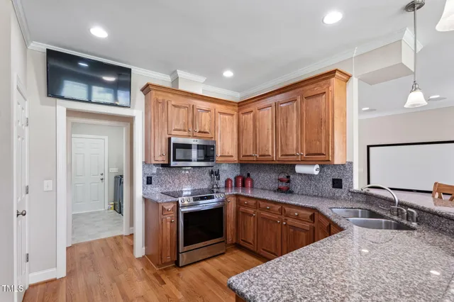 a metallic refrigerator freezer sitting in a kitchen