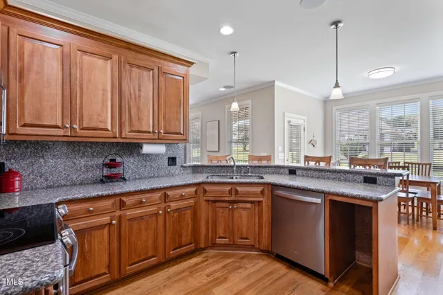 a kitchen with stainless steel appliances granite countertop a sink stove and microwave